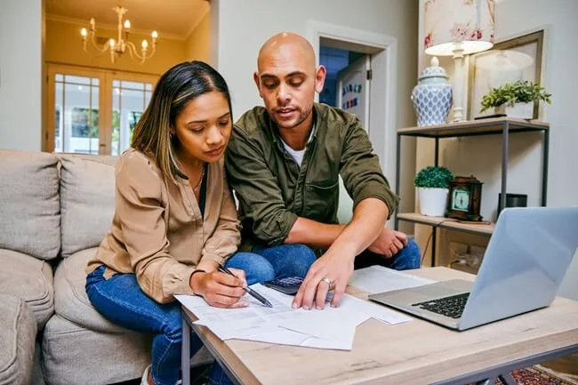 Couple fills out IRS Form 433-D to pay back taxes