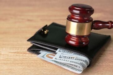 Gavel on wallet with money that the IRS is garnishing from wages