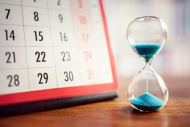 Hourglass and calendar marking the time until the IRS comes for unpaid taxes