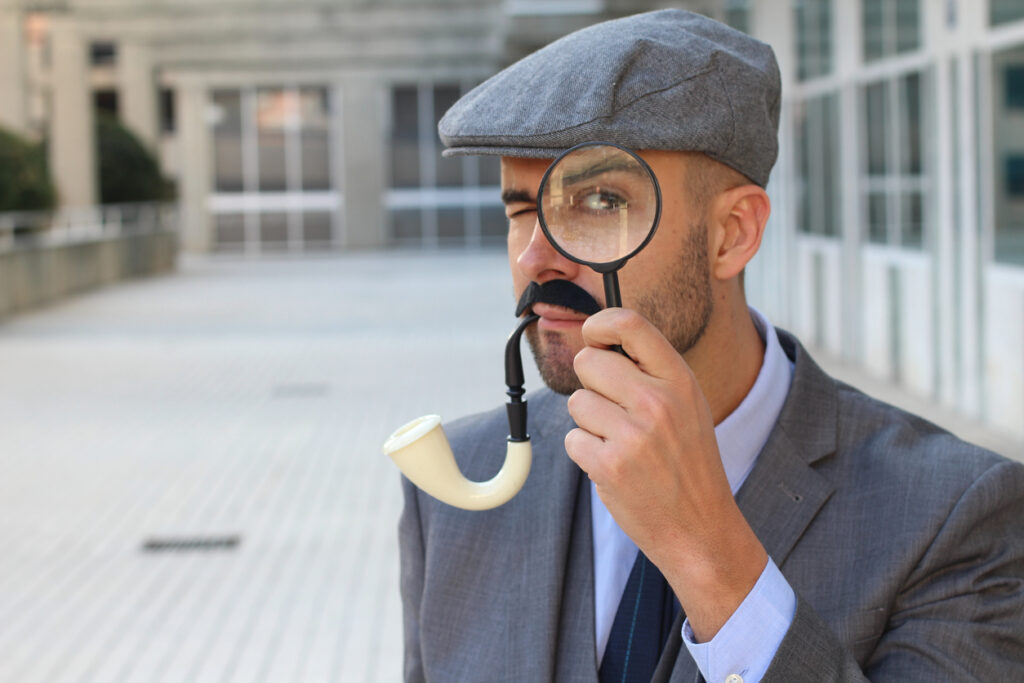 Inspector with magnifying glass close up to demonstrate suspicious IRS